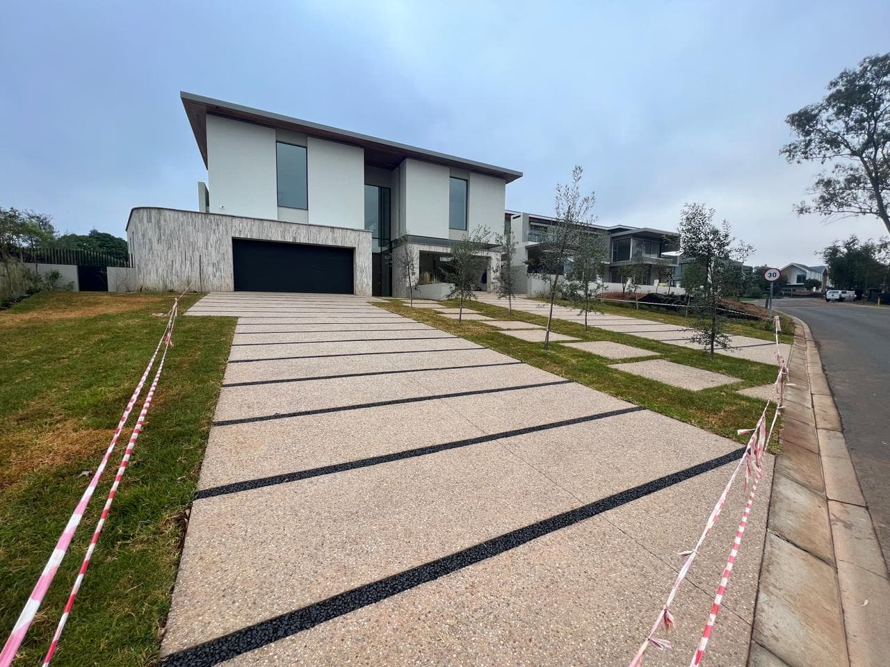 Exposed aggregate driveway with black joints on a luxury estate in Sandton